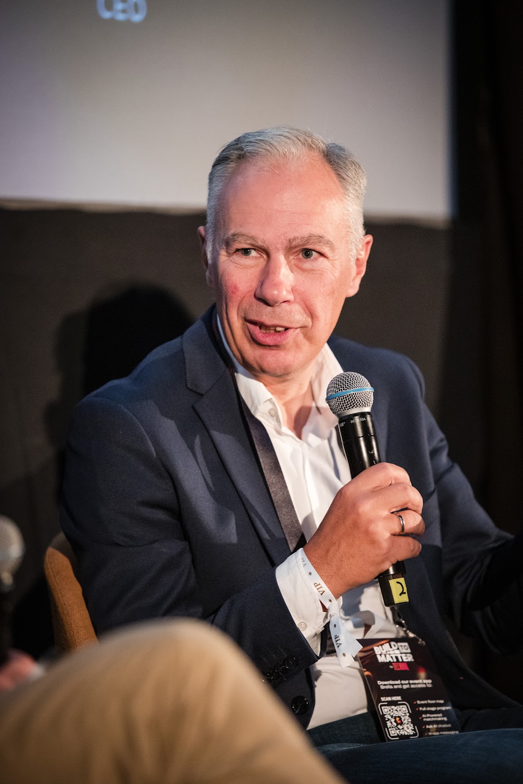 Speaker holding a microphone at Board Summit 2025